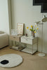 Modern living room with replica USM modular side tables, a lamp, and decorative items.