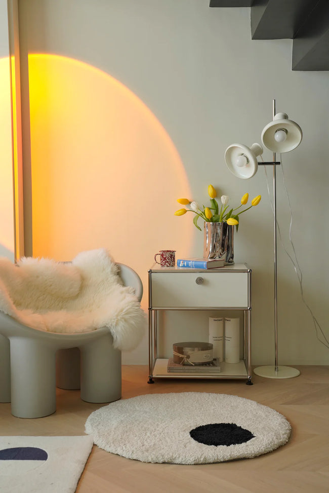 Modern interior with a chair, replica USM modular side table, and floor lamp.