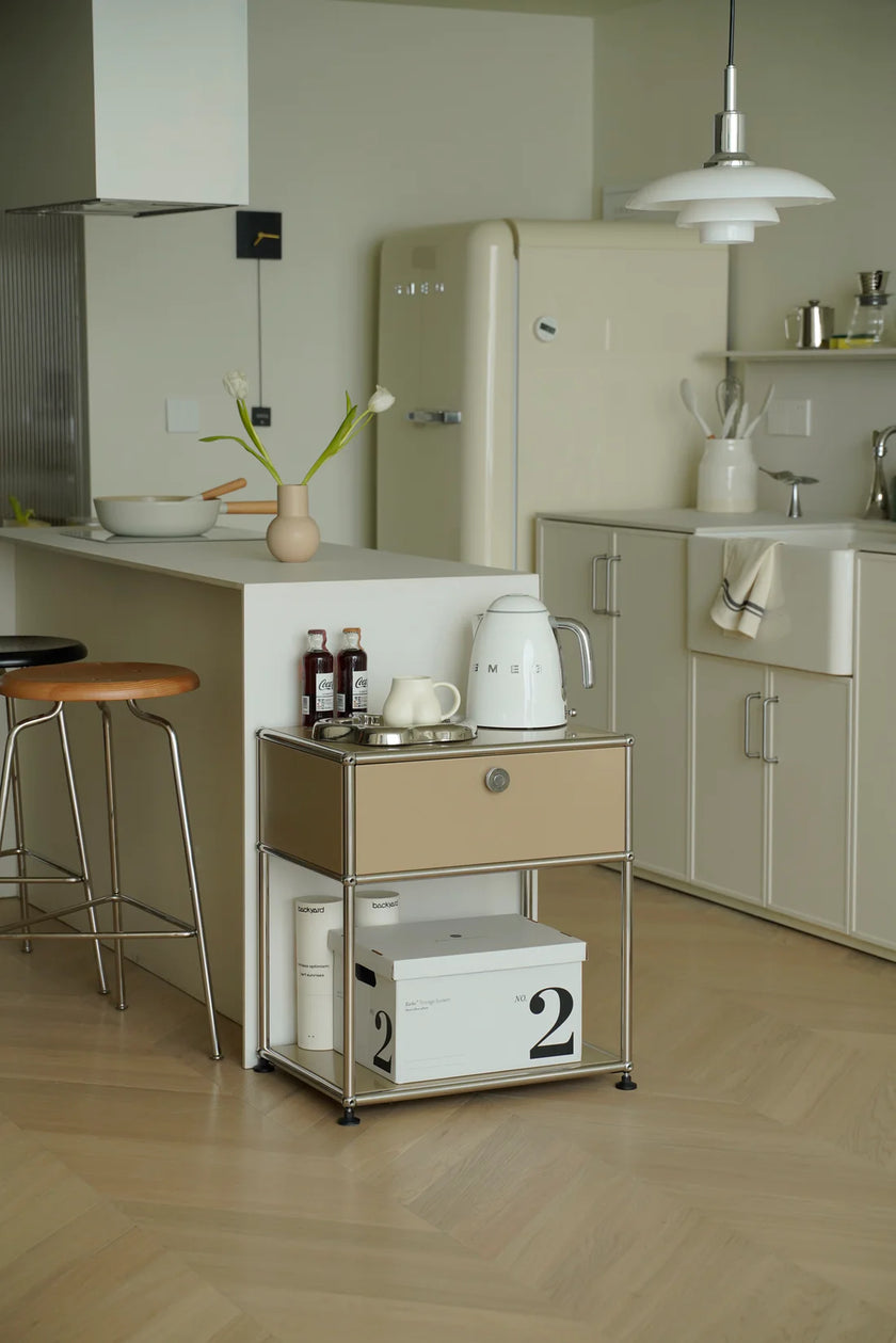 Modern kitchen with vintage-style refrigerator, inspired recreation USM modular small side table, and wooden floor.