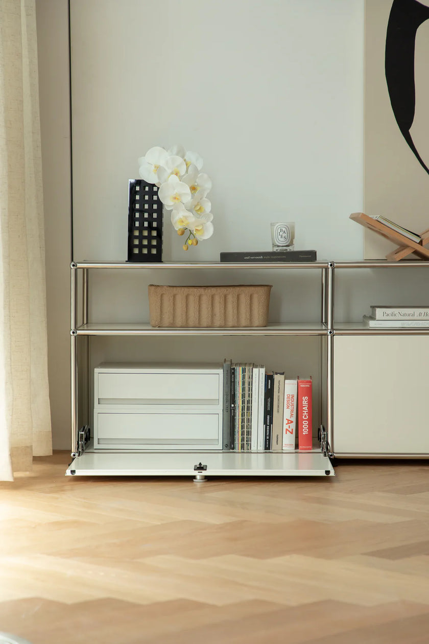 Modern inspired recreation USM modular tv stand with books and decorative items in a room setting