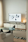 Modern living room with a television on a white replica USM modular furniture entertainment console.