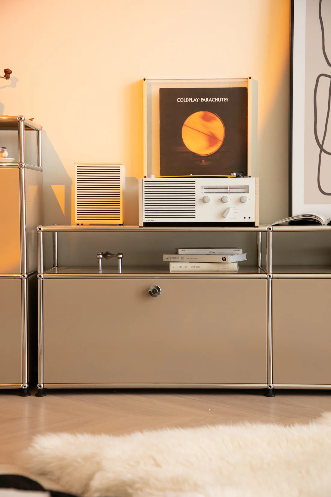Modern interior with a replica USM modular tv stand displaying a record player and album cover.