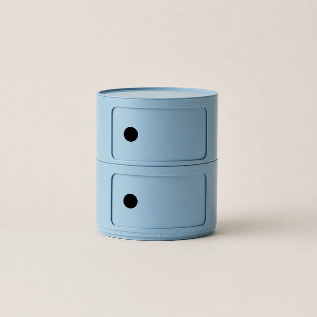 Blue cylindrical storage unit with two drawers on a beige background