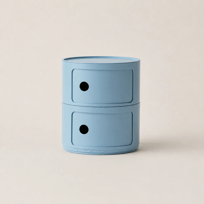 Blue cylindrical storage unit with two drawers on a beige background