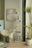 Modern interior with a white chair, white storage shelf or bookshelf, and potted plant.