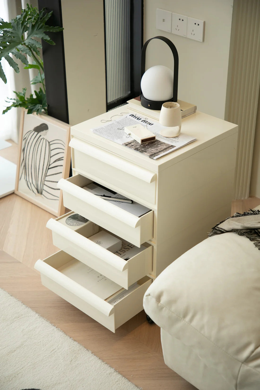 Beige storage containers with multiple drawers in a room setting.