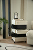 Black and white storage cube with drawers in a room setting.