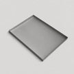 A minimalist rectangular metal tray with a thin silver frame, shown at an angle on a light gray background.