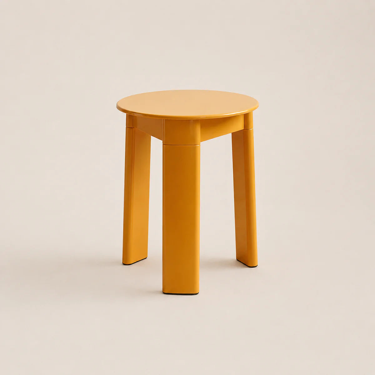 Yellow stool on a beige background