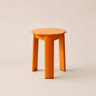 Orange stool on a beige background