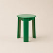 Green stool on a beige background