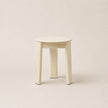 White stool on a beige background
