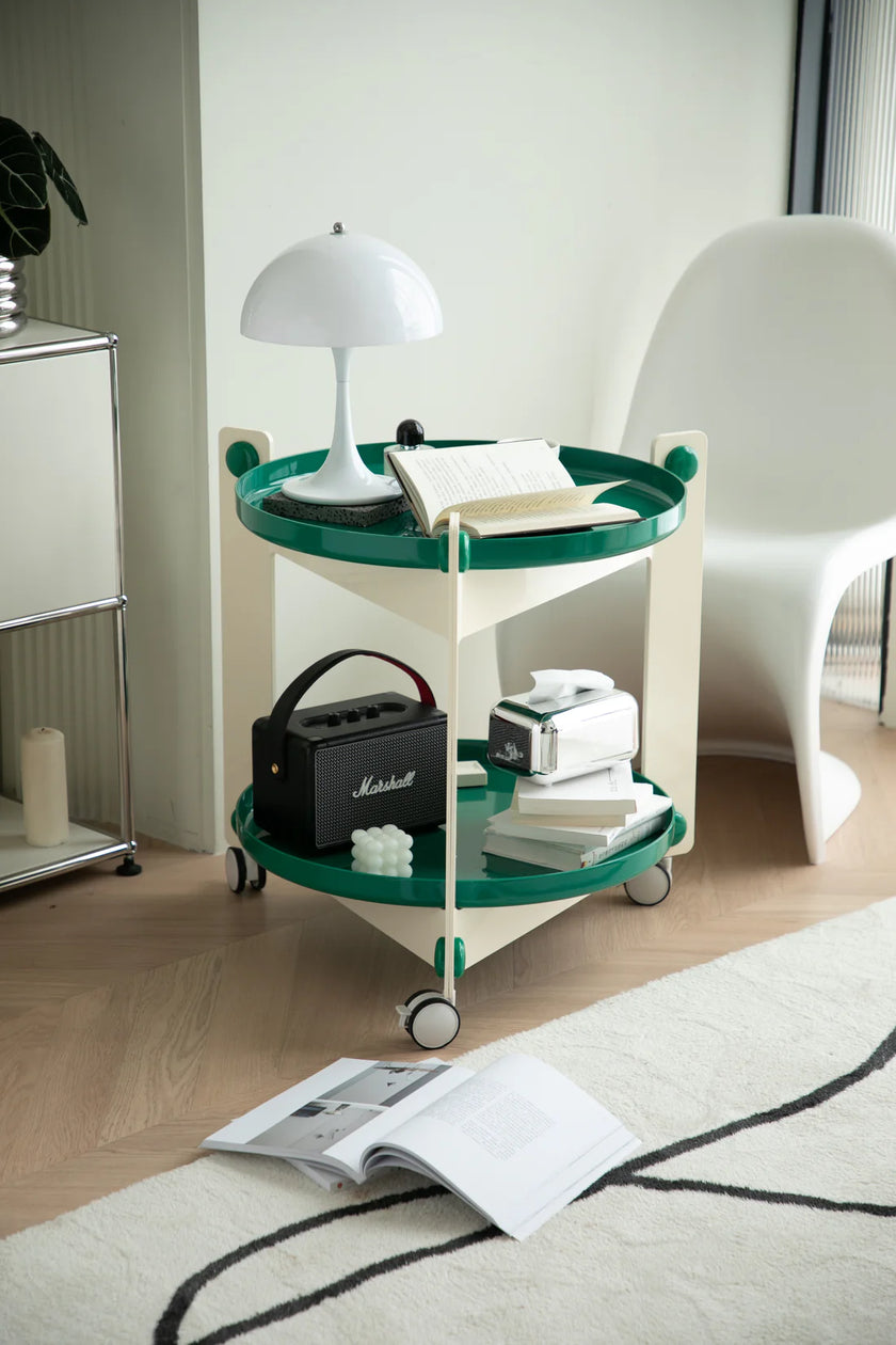 Green and white rolling cart with drawers with various items in a room setting