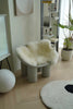 Modern chair with wool blanket cover in a minimalistic room
