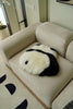 Panda-shaped pillow on a beige sofa in a living room setting