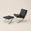 Black leather chair and ottoman on a beige background
