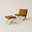 Brown leather chair and ottoman on a beige background