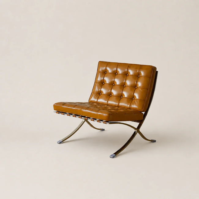 Brown leather chair with metal legs on a beige background