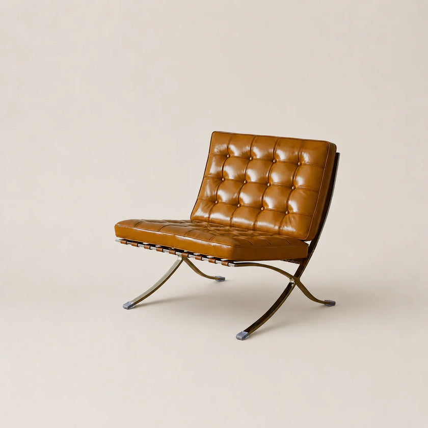 Brown leather chair with metal legs on a beige background