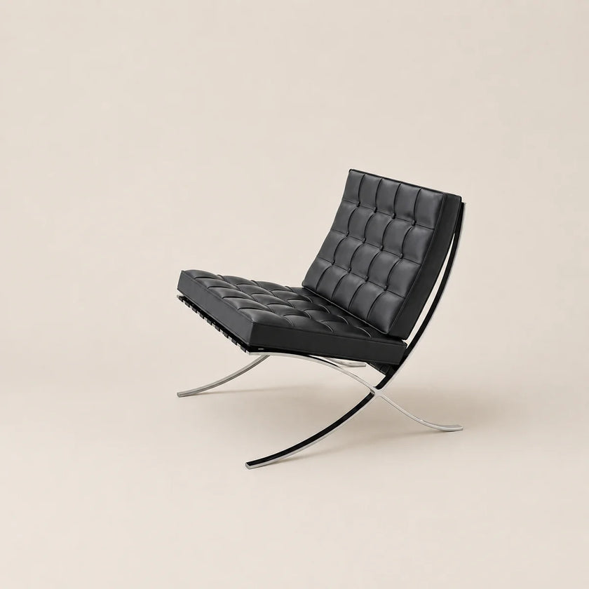 Modern black leather chair with chrome frame on a beige background