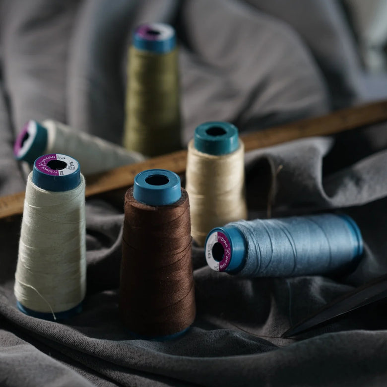 Spools of thread on a fabric background