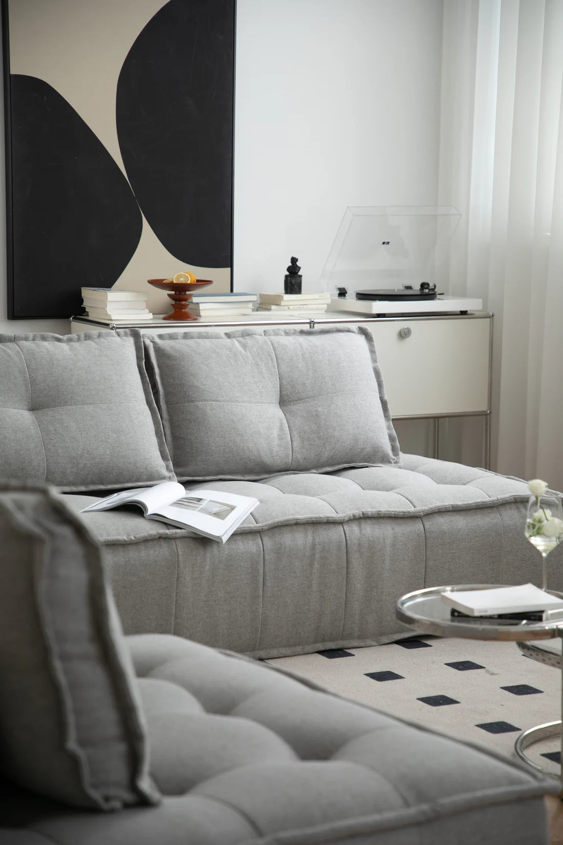 Gray sectional sofa in a living room with a coffee table and decorative items.