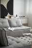 Gray sectional sofa in a living room with a coffee table and decorative items.