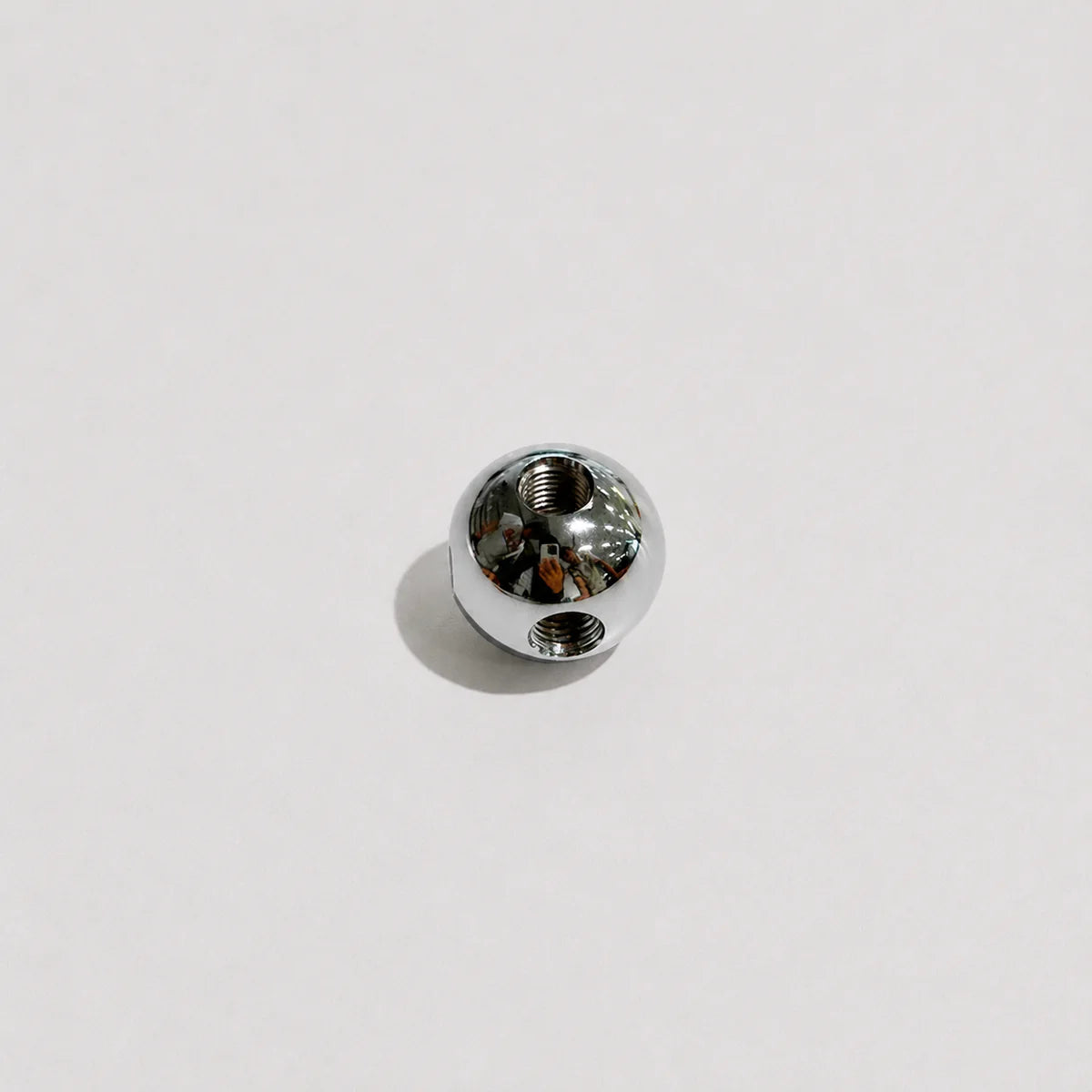 A single small 8K polished metal bead or charm with a threaded hole, shown on a plain light gray background.