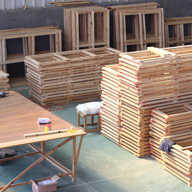 Stacks of wooden crates and tables in a warehouse setting