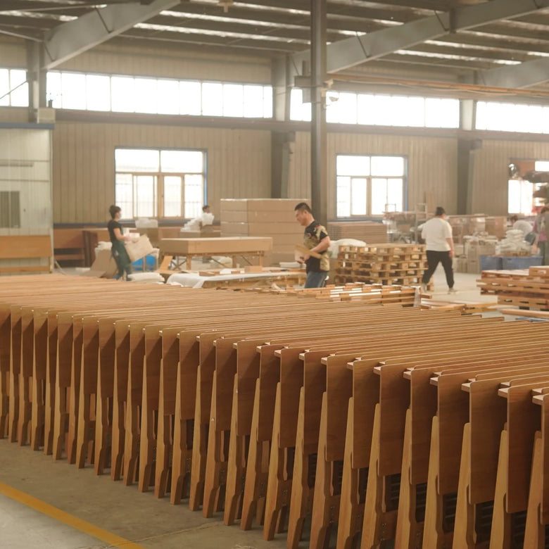 Factory interior with wooden panels and workers in a large industrial setting