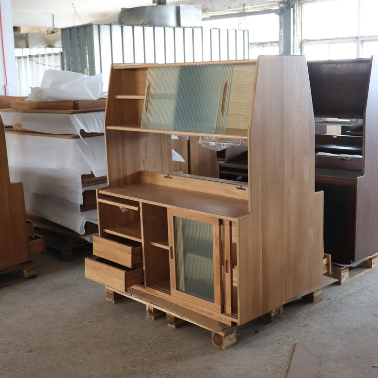 Wooden office partition with glass panels on a concrete floor.