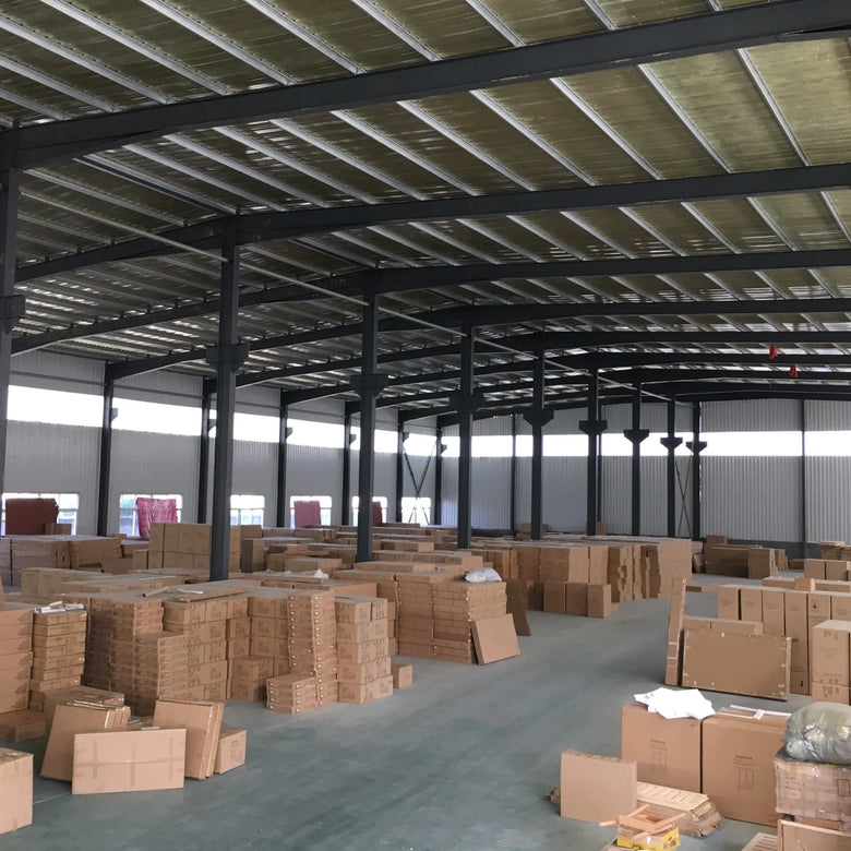 Large warehouse with stacked cardboard boxes on a concrete floor.