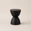 Black geometric stool on a beige background