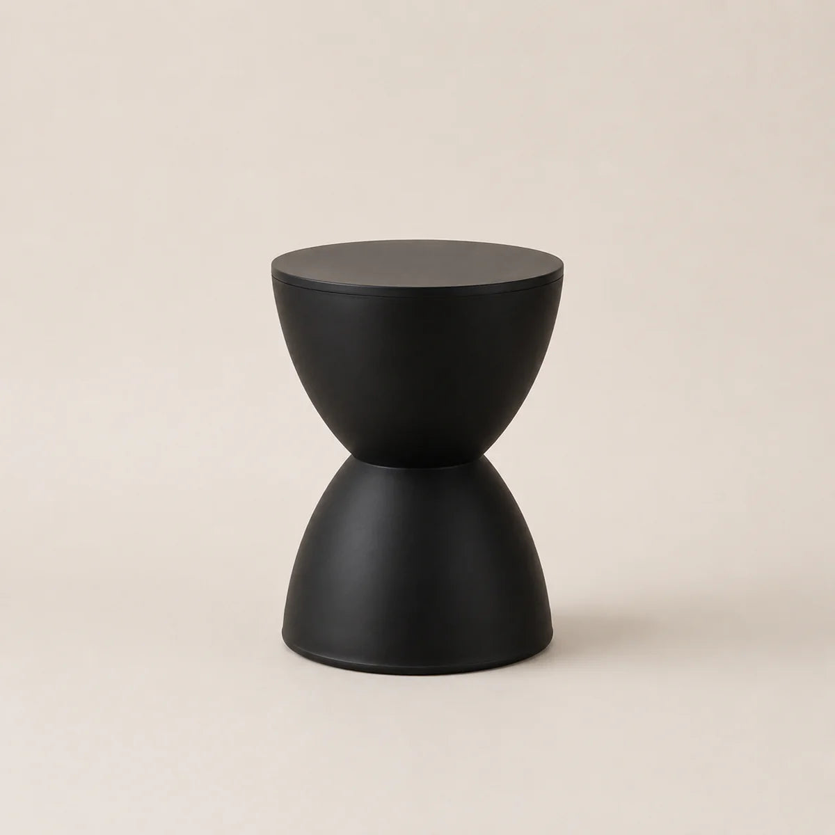 Black geometric stool on a beige background