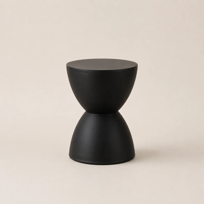 Black geometric stool on a beige background