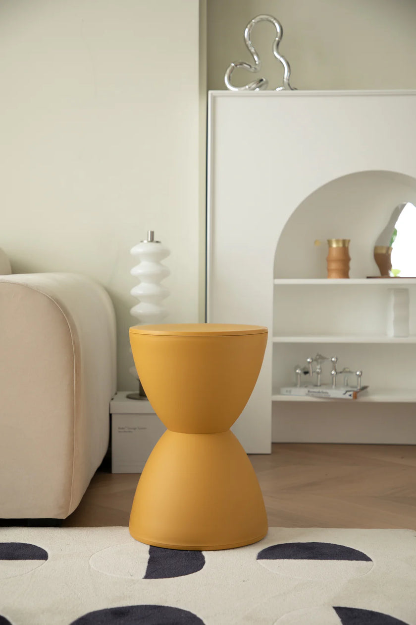 Yellow bathroom stool in a modern living room setting with a neutral color palette.