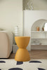 Yellow bathroom stool in a modern living room setting with a neutral color palette.