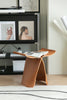 Wooden stool side table with magazines in a living room setting