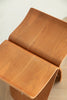 Wooden stool with a curved design on a light background