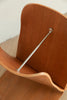 Wooden chair with a metal armrest on a plain background
