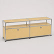 A modular storage cabinet with a minimalist design, featuring pale yellow fabric upholstery and a chrome steel frame, set against a neutral light gray background.