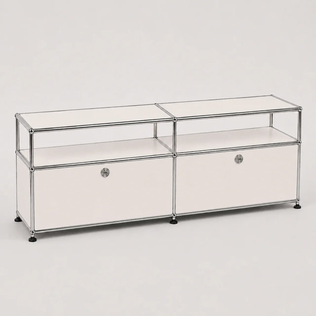 A modern modular storage cabinet with a chrome metal frame, clear glass shelves, and white drawer fronts with round silver knobs, set against a plain light gray background.
