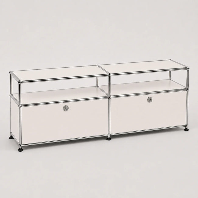 A modern modular storage cabinet with a chrome metal frame, clear glass shelves, and white drawer fronts with round silver knobs, set against a plain light gray background.