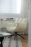 Beige leather swivel armchair in a room with a window and rug