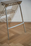 Metal & abs ladder rack with transparent backrest on a wooden floor