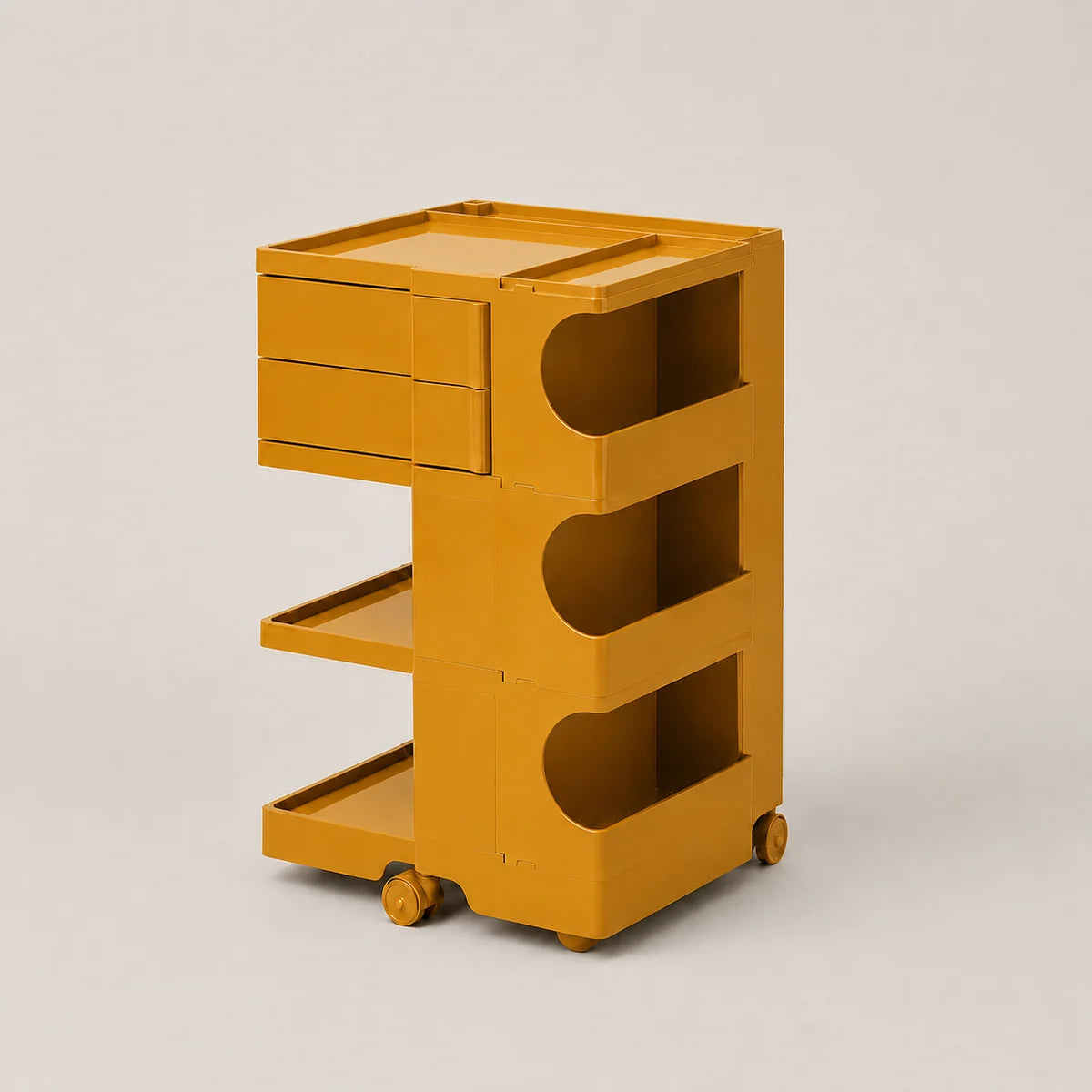 A ginger yellow rolling storage cart with two drawers on the left, three open shelves with curved cutouts, and small caster wheels, photographed on a plain light gray studio background.