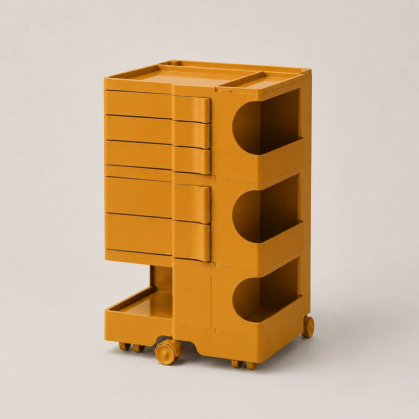A mustard yellow rolling storage cart with multiple drawers and open shelves, photographed on a clean light gray studio background.