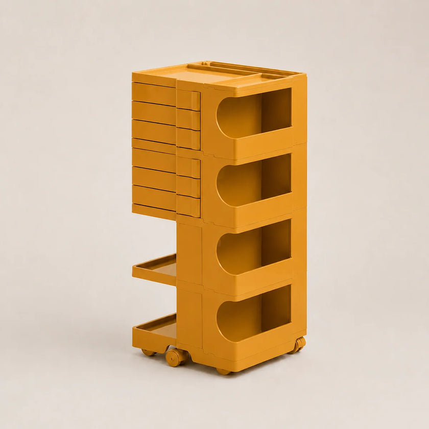 A mustard yellow storage cart with multiple drawers, open shelves, and wheels, shown on a neutral light gray background.