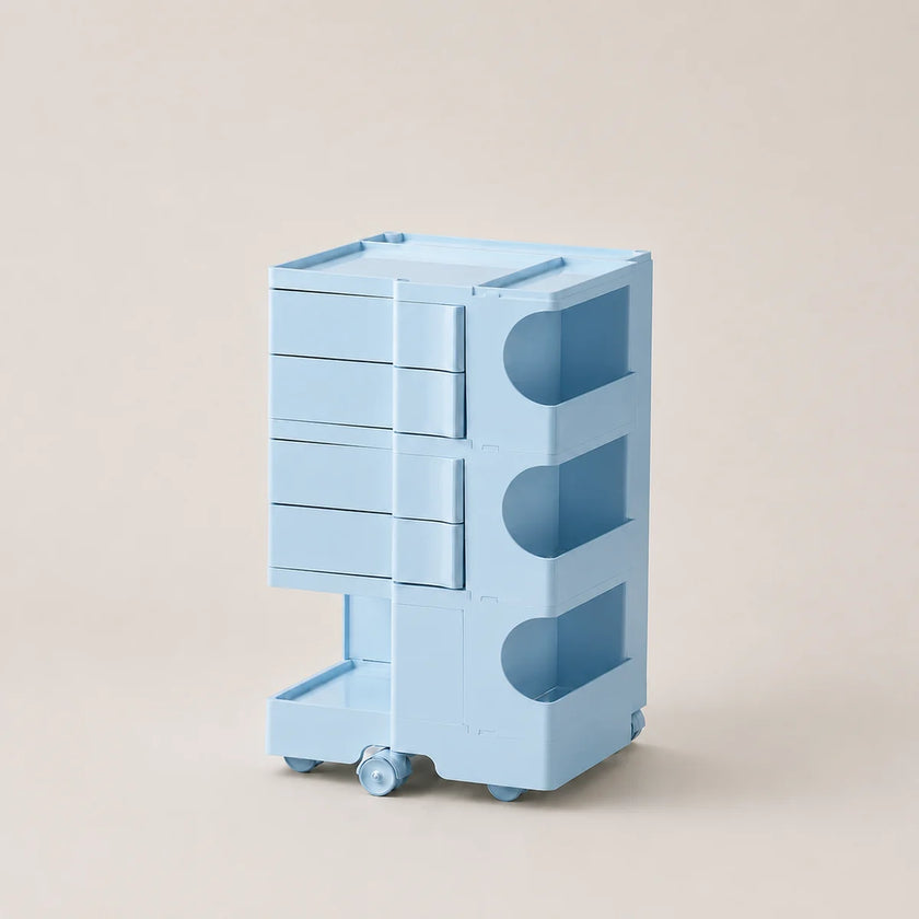 A light blue rolling storage organizer with four drawers on the left and three open shelves on the right, set against a solid beige background.