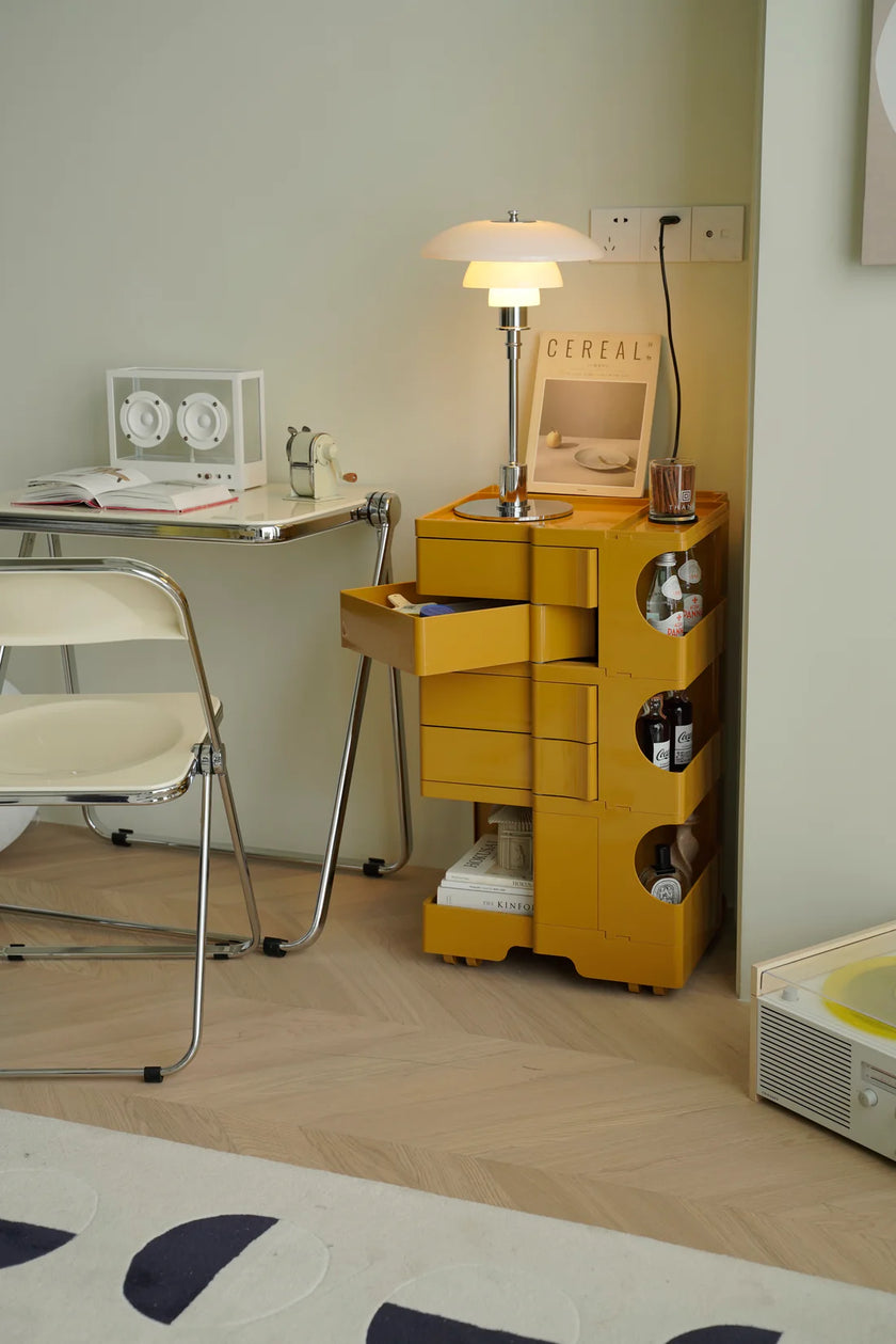 Yellow storage unit with drawers and shelves in a room setting.